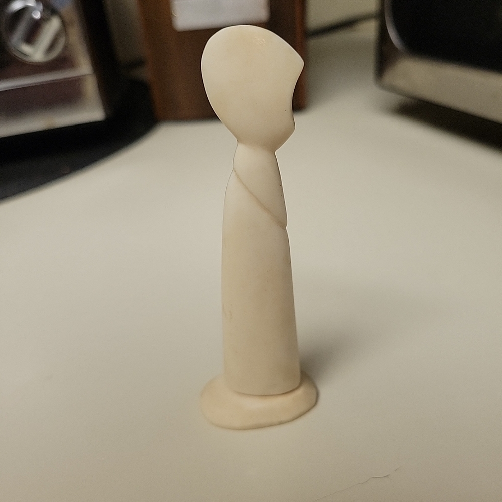 Genuine ivory like figurine of a child.